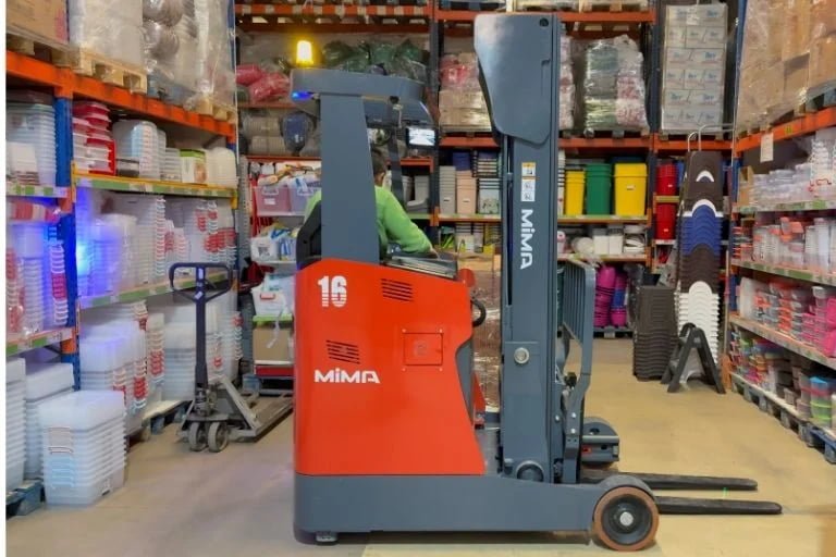 Electric forklift operating inside a retail and supermarket environment