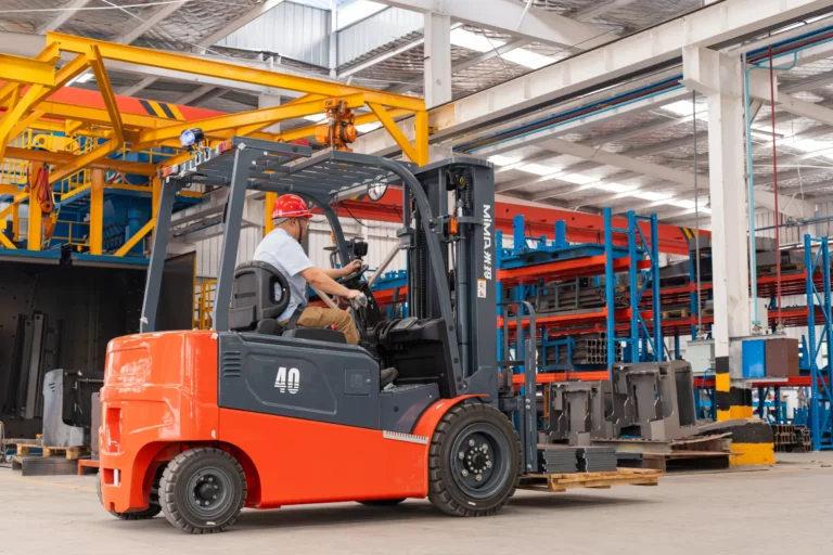 Electric forklift operating inside a manufacturing facility