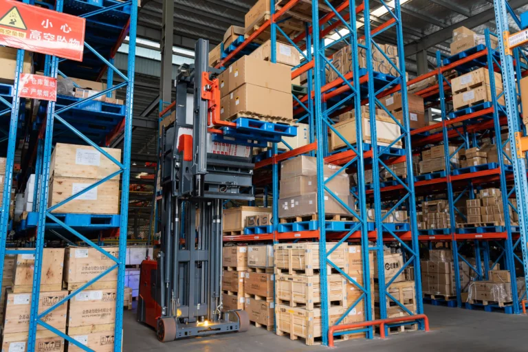 Electric forklift operating inside a warehouse and distribution center